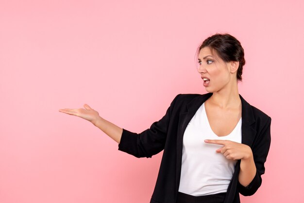 Front view young female in dark jacket on a pink background