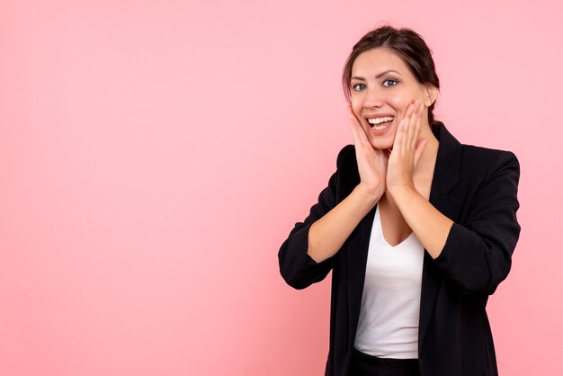 Front view young female in dark jacket on a pink background