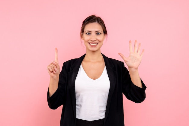 Front view young female in dark jacket on pink background