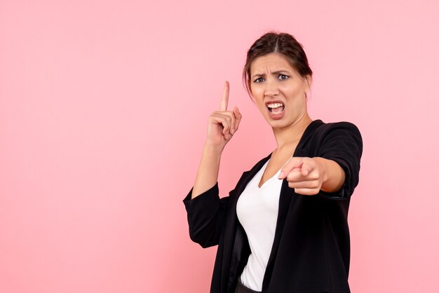 Front view young female in dark jacket on pink background