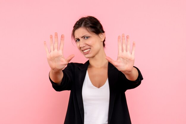 Front view young female in dark jacket on pink background