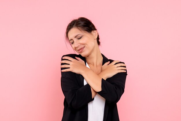 Front view young female in dark jacket on pink background