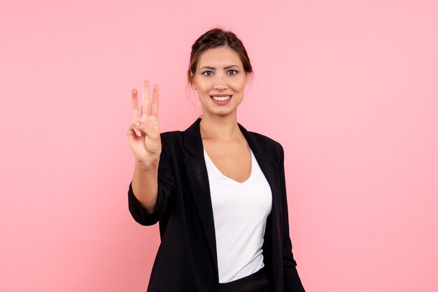 Front view young female in dark jacket on pink background