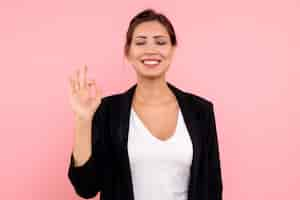 Free photo front view young female in dark jacket on pink background