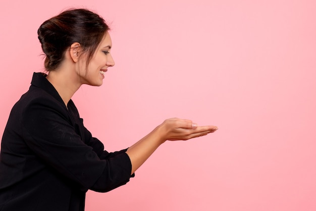 Free photo front view young female in dark jacket on pink background