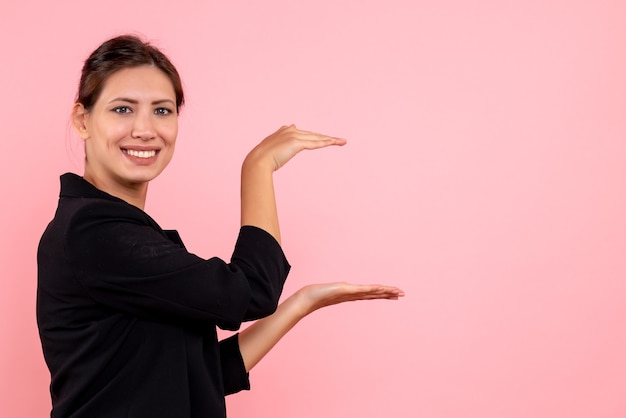 Front view young female in dark jacket on pink background