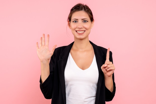 Free photo front view young female in dark jacket on pink background