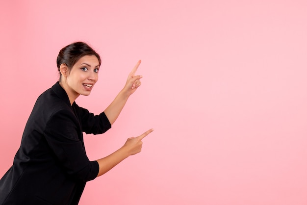 Front view young female in dark jacket on pink background