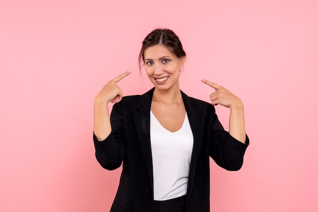 Free photo front view young female in dark jacket on pink background