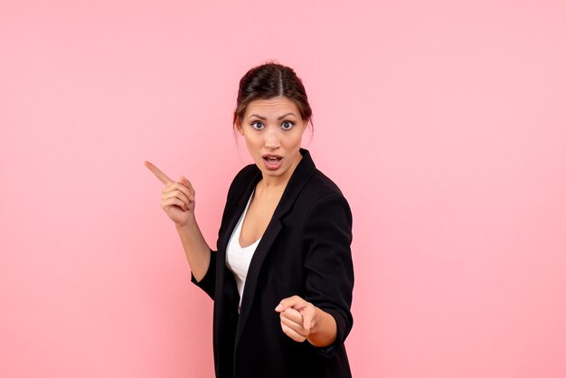 Front view young female in dark jacket on pink background