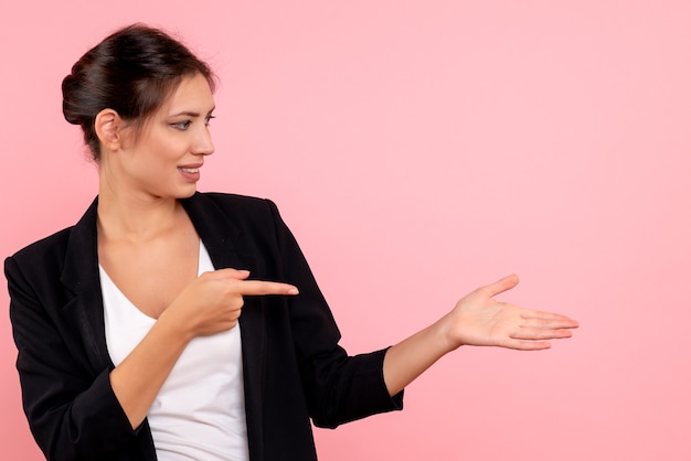 Free photo front view young female in dark jacket on pink background