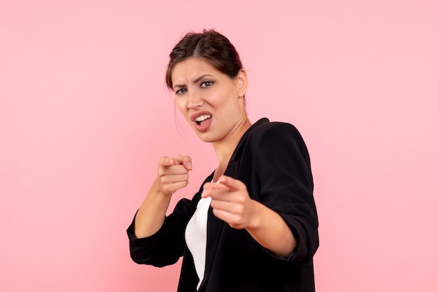 Front view young female in dark jacket on pink background