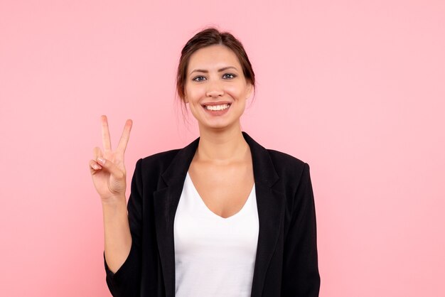 Front view young female in dark jacket on pink background