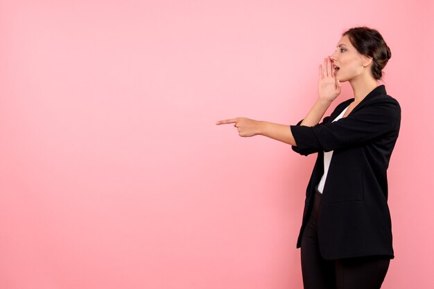 Front view young female in dark jacket on the pink background