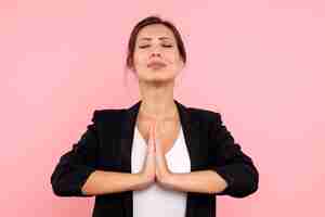 Free photo front view young female in dark jacket praying on pink background