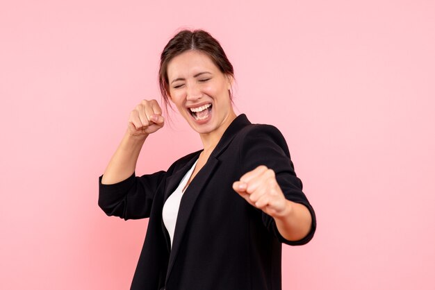 Front view young female in dark jacket rejoicing on pink background