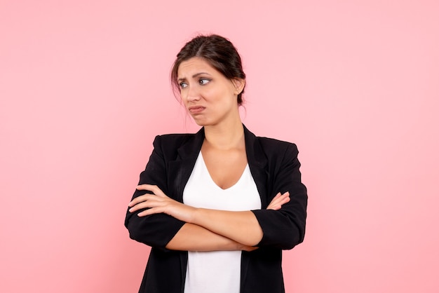 Front view young female in dark jacket stressed on a pink background