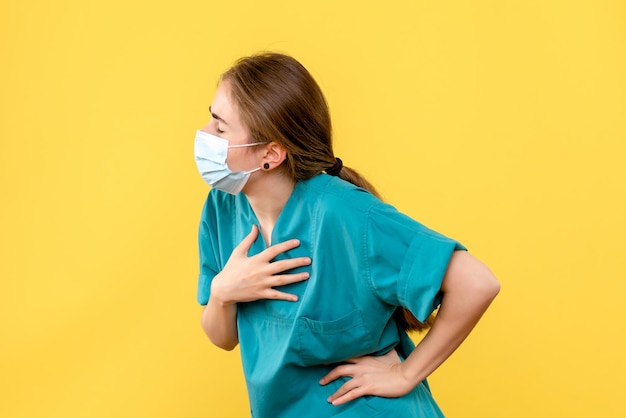 Front view of young female doctor having breath problems