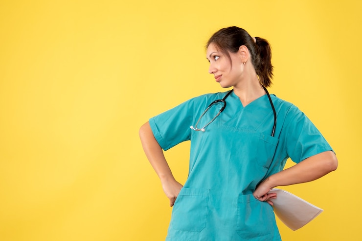 Free Photo front view young female doctor in medical shirt holding paper analysis on yellow background