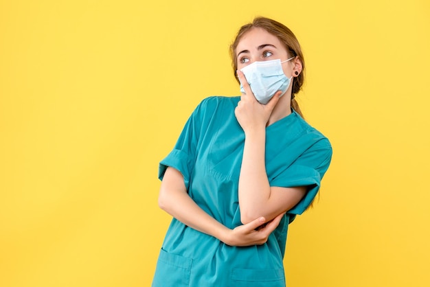 Front view of young female doctor thinking