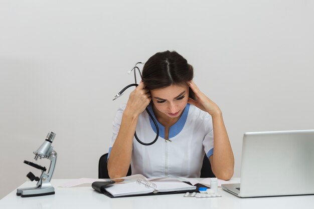 Front view young female doctor thinking