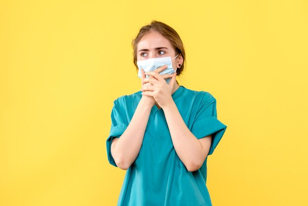 Front view of young female doctor worried