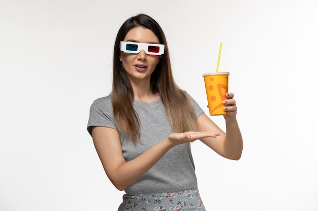 Front view young female drinking soda in d sunglasses on white desk