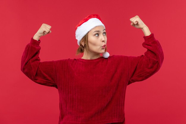 Front view young female flexing, christmas holiday red