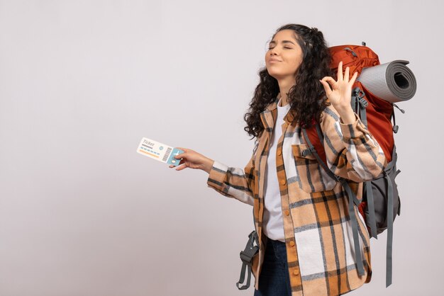 Front view young female going in hiking holding ticket on the white background air tourist forest vacation flight trip campus mountain