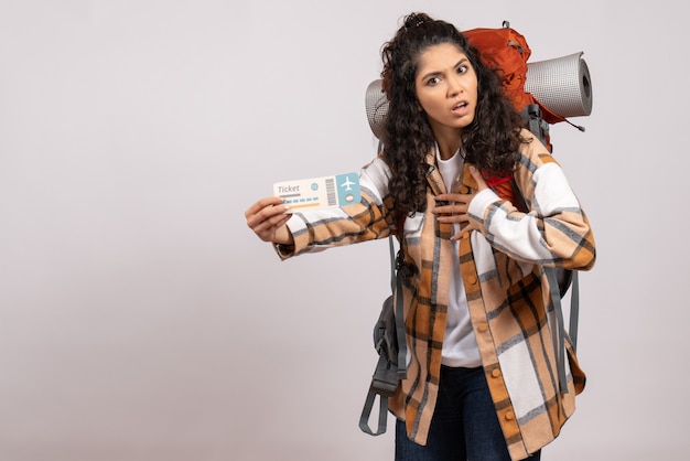 Free photo front view young female going in hiking holding ticket on white background trip air tourist forest vacation flight campus mountain