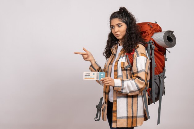 Front view young female going in hiking holding ticket on white background trip tourist vacation campus air mountain forest