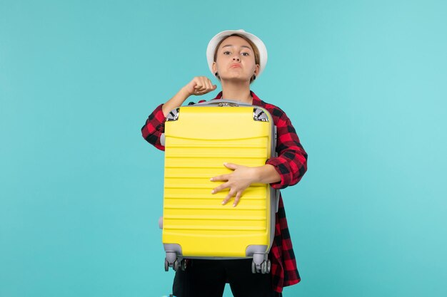 Front view young female going in vacation with her big bag on blue space