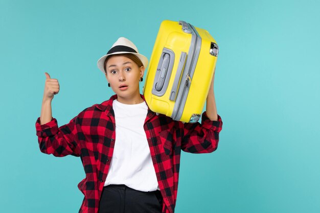 Front view young female going in vacation with her big bag on blue space