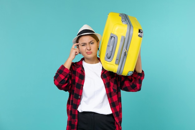 Front view young female going in vacation with her big bag on blue space