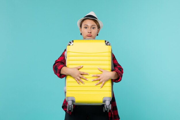 Front view young female going in vacation with her big bag on light blue space