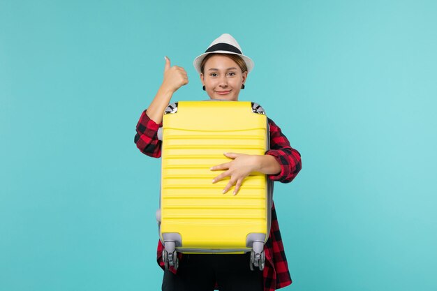 Free photo front view young female going in vacation with her big bag smiling on blue space