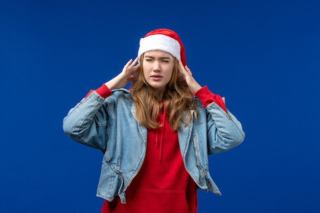 Front view young female having headache on a blue background christmas emotion color