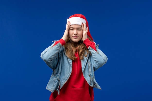 Front view young female having headache on blue background christmas emotion color