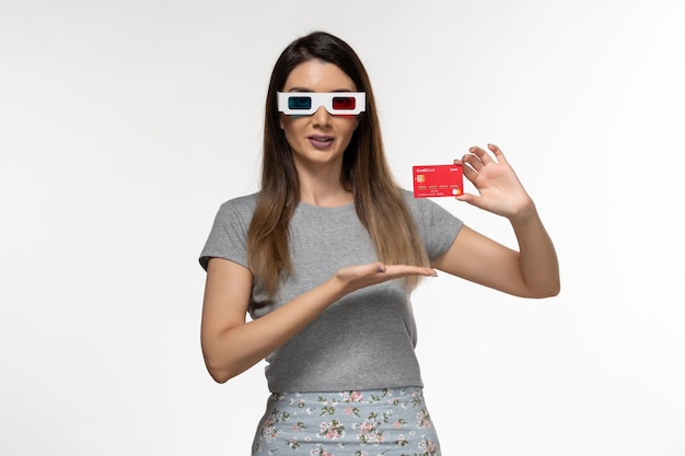 Front view young female holding bank card in d sunglasses on white surface