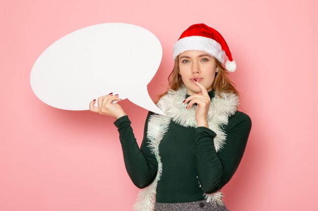 Front view young female holding big white sign on pink wall christmas new year model holiday color emotions