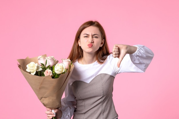 Front view young female holding bouquet of beautiful roses on pinks