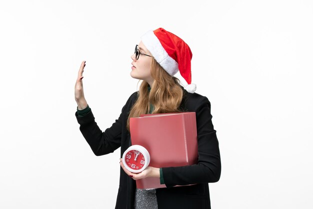 Front view young female holding clock and files on white desk lesson college book