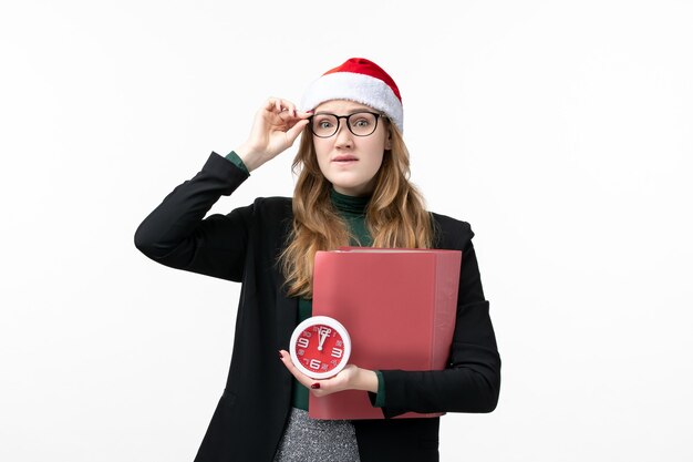 Front view young female holding clock and files on white wall book lessons college