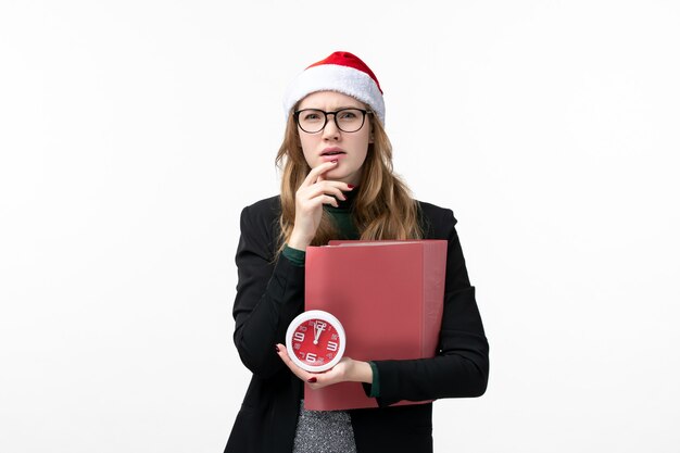 Front view young female holding clock and files on white wall books lesson college