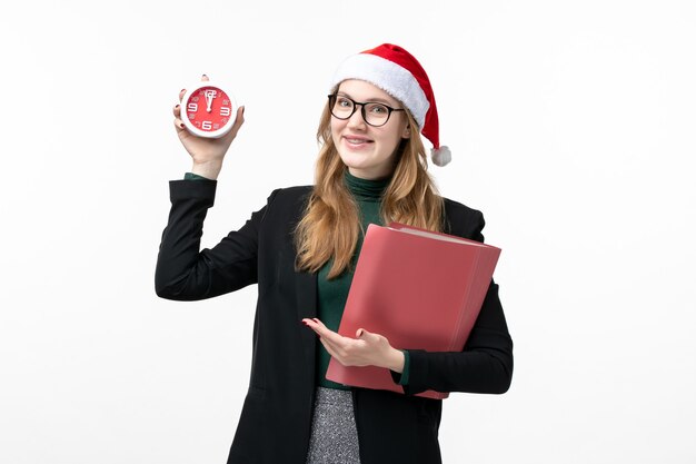 Front view young female holding files and clock on white wall books lesson college