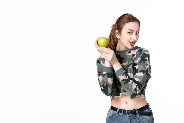 Front view young female holding green apple white background horizontal fruit diet healthcare human dish juice wellness