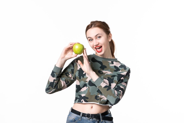 Front view young female holding green apple white background meal human fruit juice colours shot diet dish food tree gun