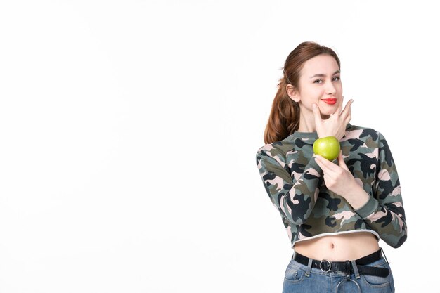 Front view young female holding green apple white