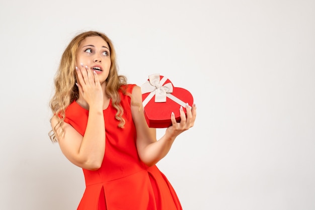 Front view young female holding heart shaped present