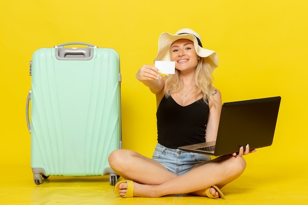 Front view young female holding her laptop and card